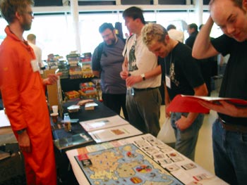 Check out the guy on the right scratching his head as he reads the rules.