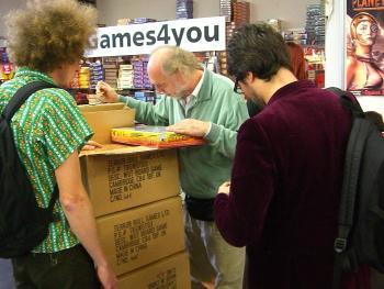 A fellow games designer and store owner inspects the goods