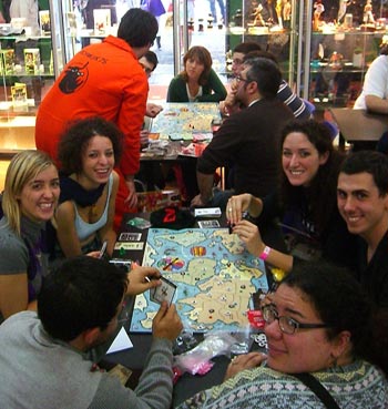 Andy S presides over two simultaneous demo games of WoT. The number of smiling faces shows you they're either playing it wrong, or they've only just started.