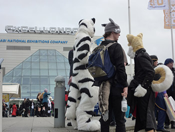 Some furries gather at the entrance to Excel