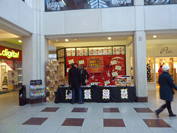 The early bird catches the satirical board game. Tom serves our first customer.