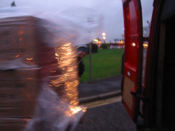 Andy S oversees a blurry polythene-wrapped bundle being shunted into the van.
